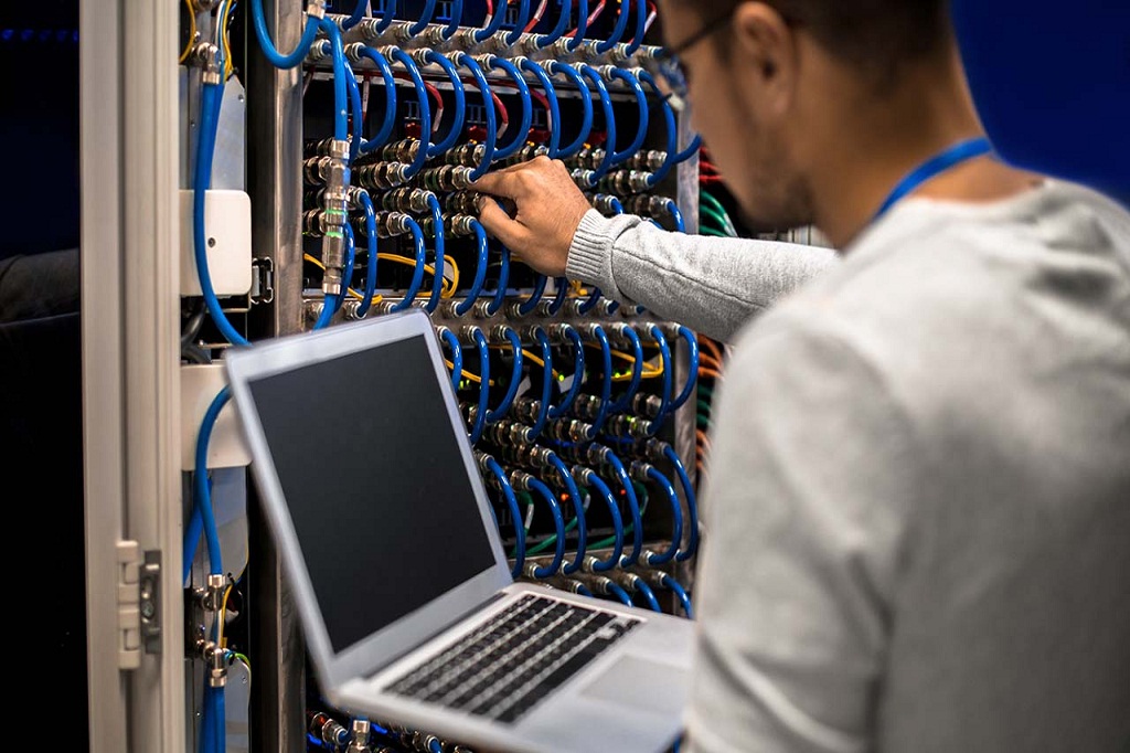 Back view of hackers working on making a dangerous malware